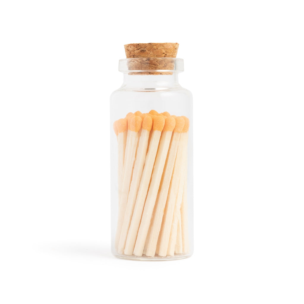 apricot orange color tip wood matchsticks in corked vial with match striker