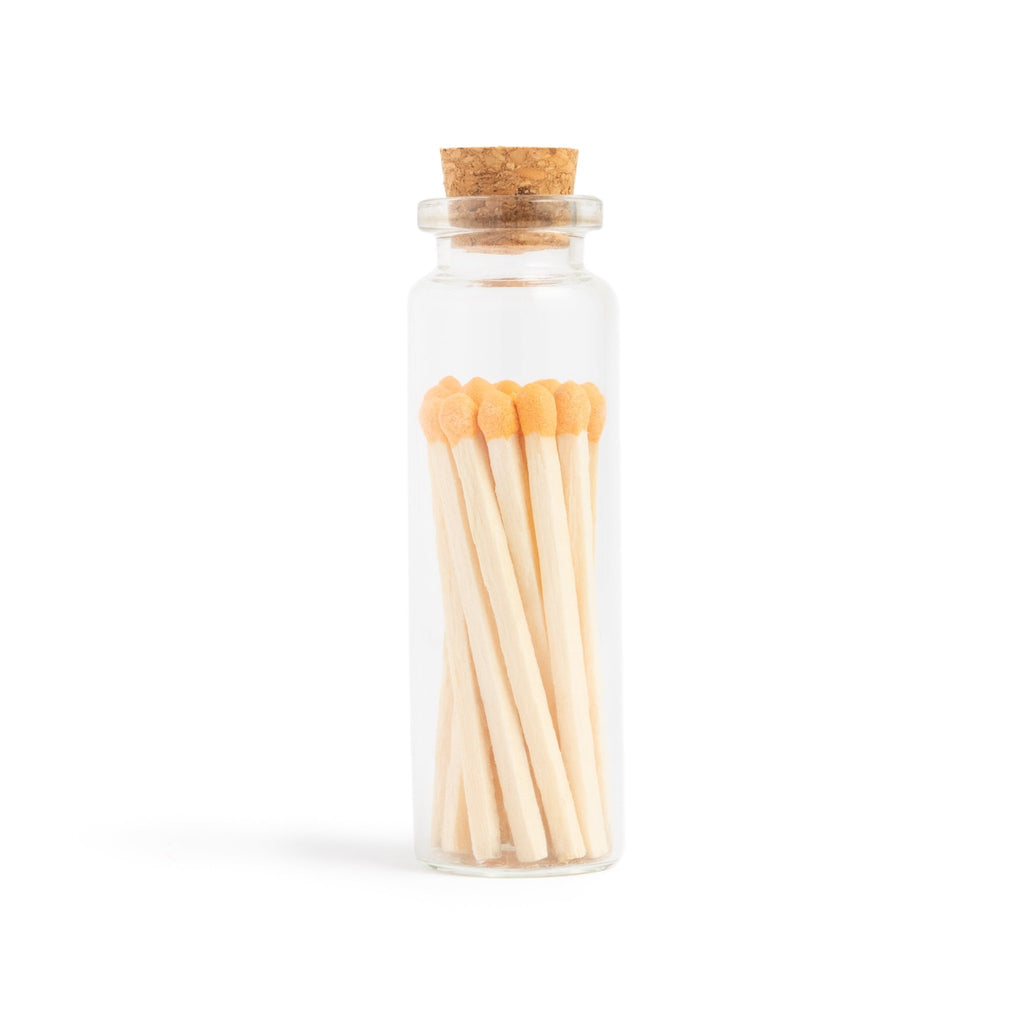 apricot orange color tip wood matchsticks in corked vial with match striker