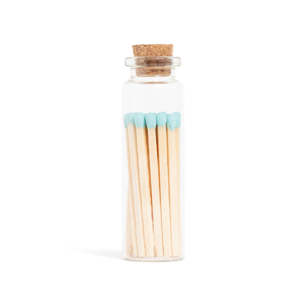 baby blue color tip wood matchsticks in corked vial with match striker