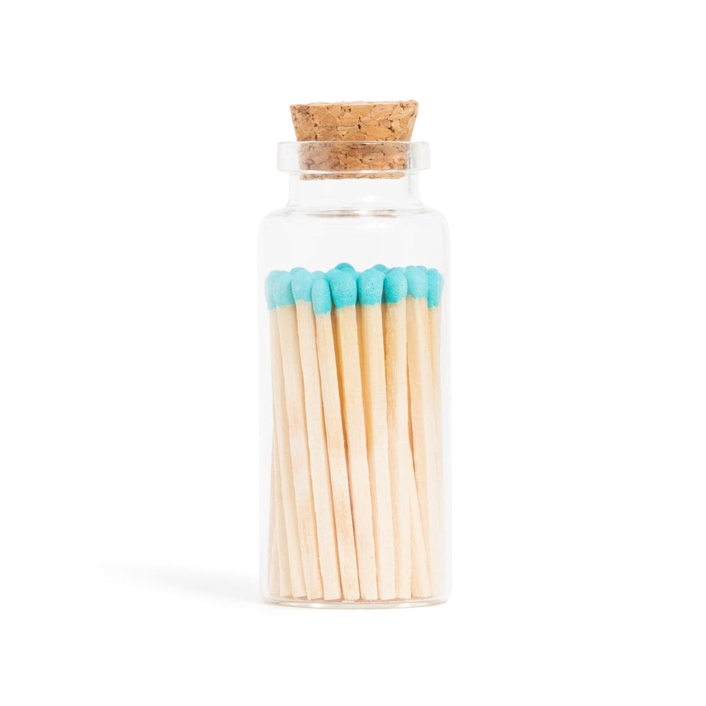 blue tip wooden matchsticks in corked jar with match striker