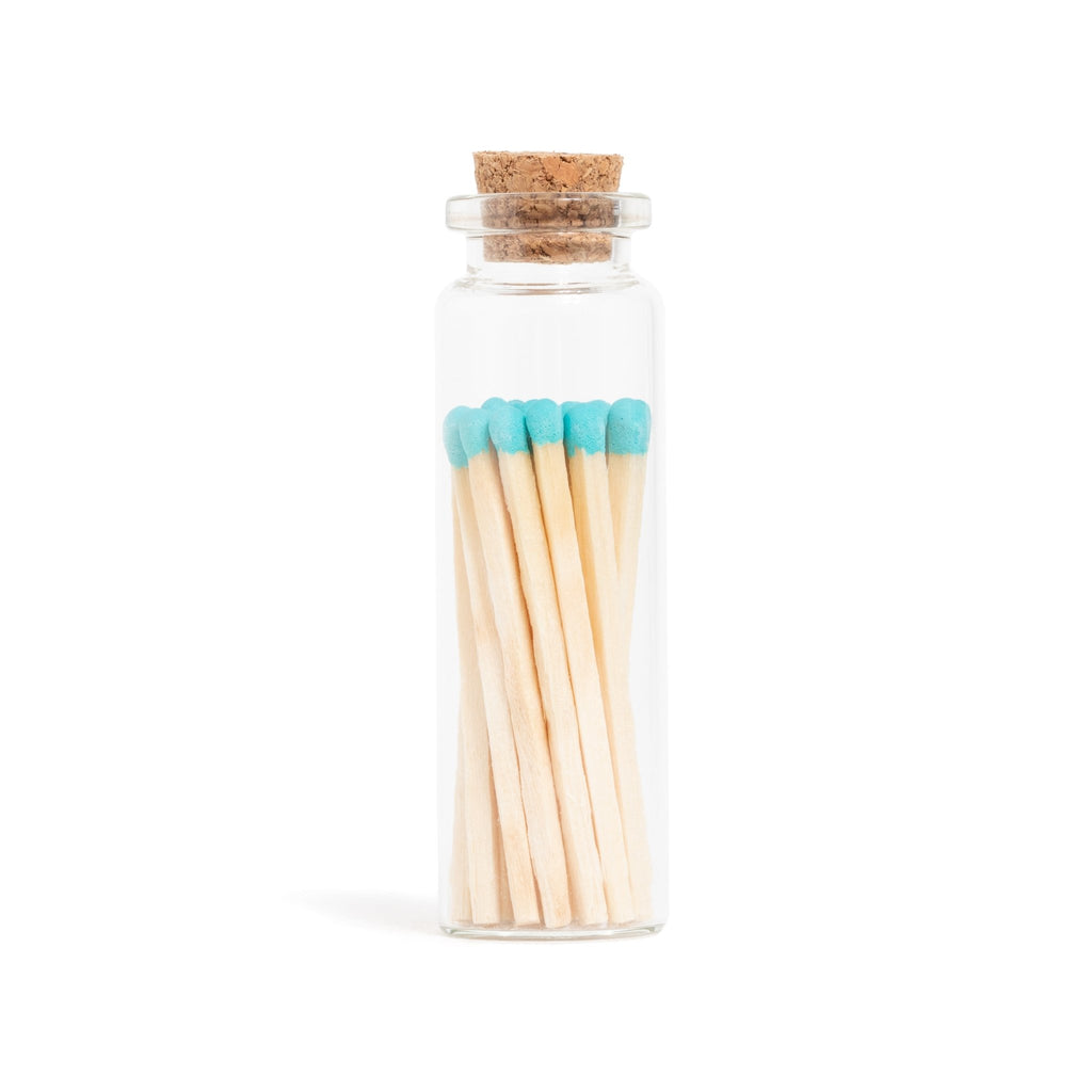 blue tip wooden matchsticks in corked jar with match striker