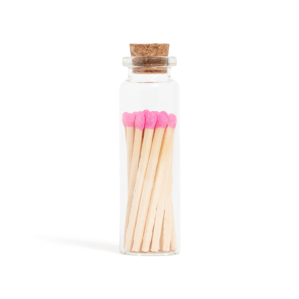 pink matchsticks in corked jar with match striker