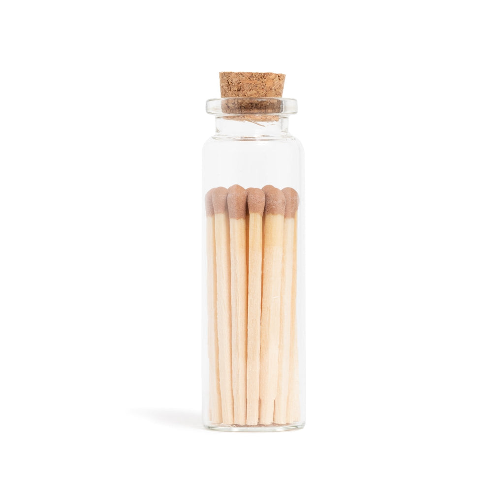 brown matchsticks in corked jar with match striker