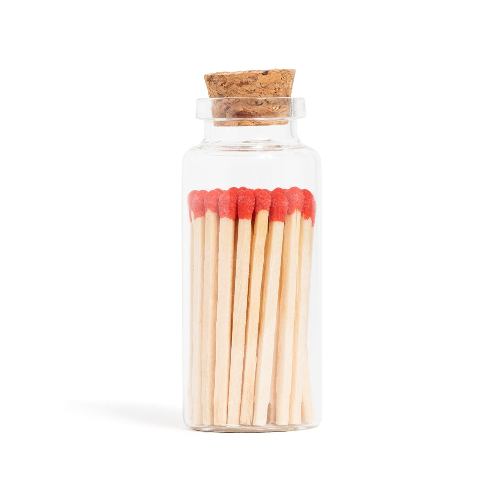 red matchsticks in corked jar with match striker