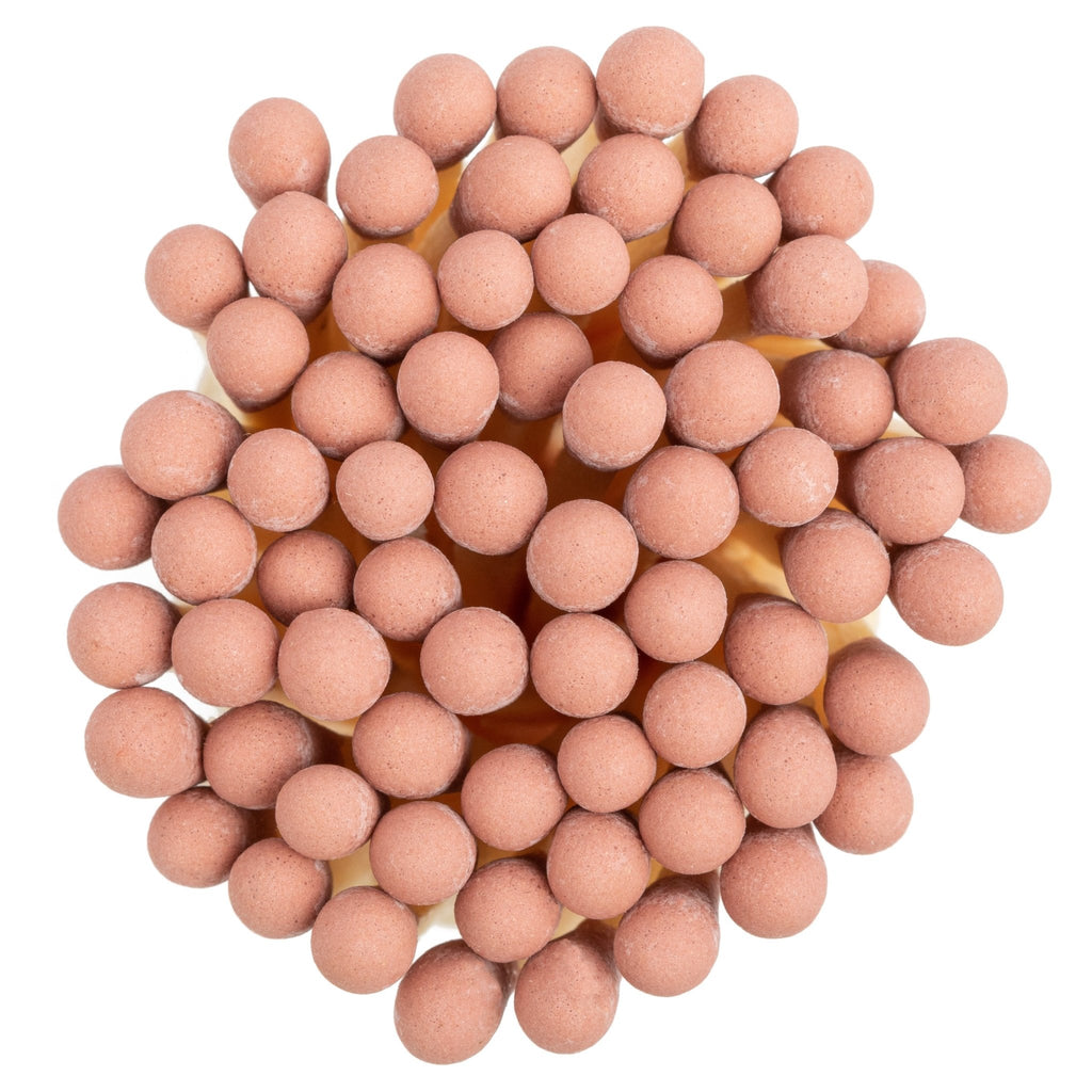 dusty rose color tip wood matchsticks in corked jar with match striker