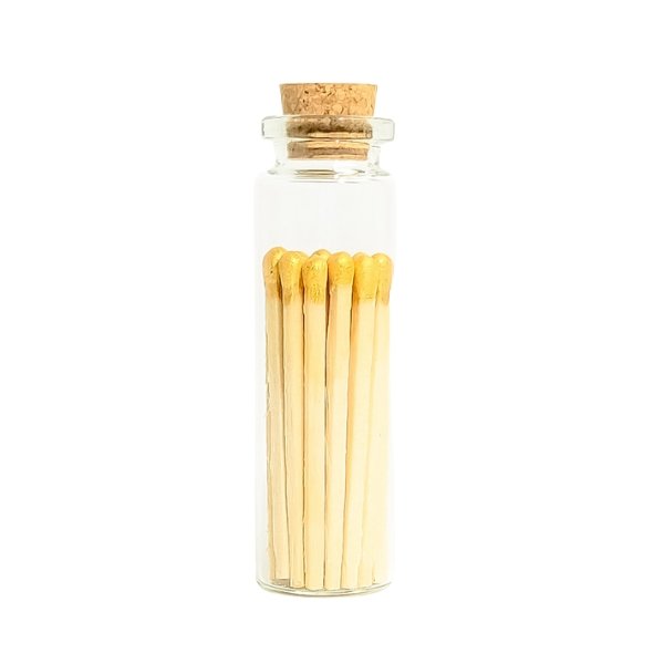 gold color tip wood matchsticks in corked jar with match striker
