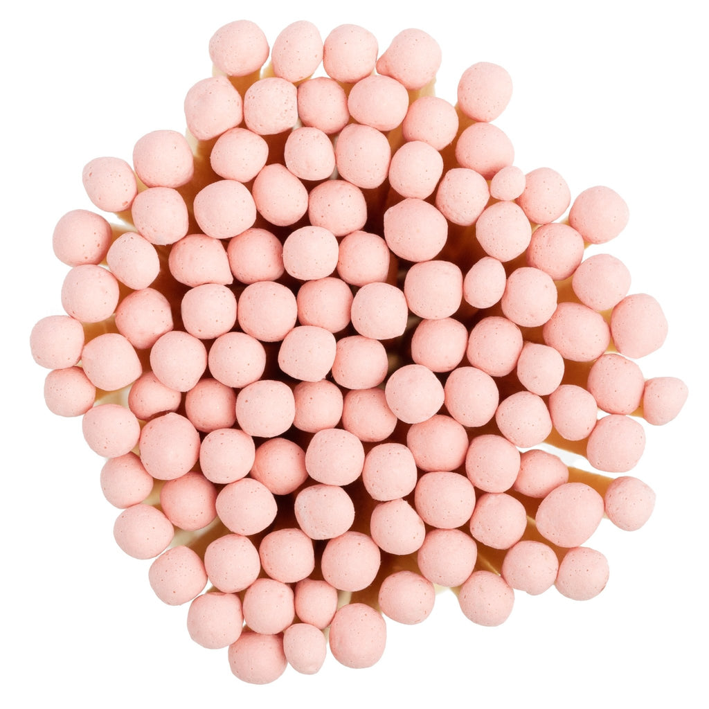white concrete match jar with colorful matchsticks and match striker