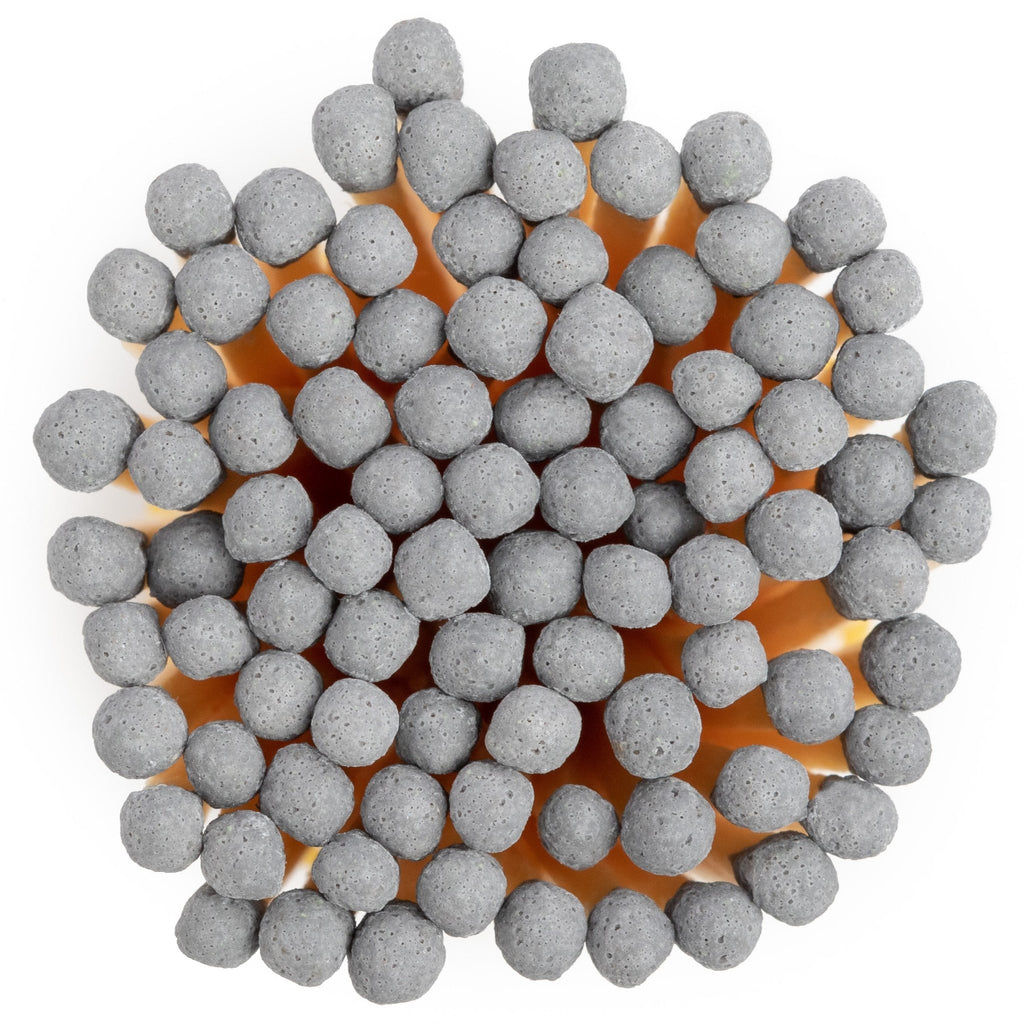white concrete match jar with colorful matchsticks and match striker